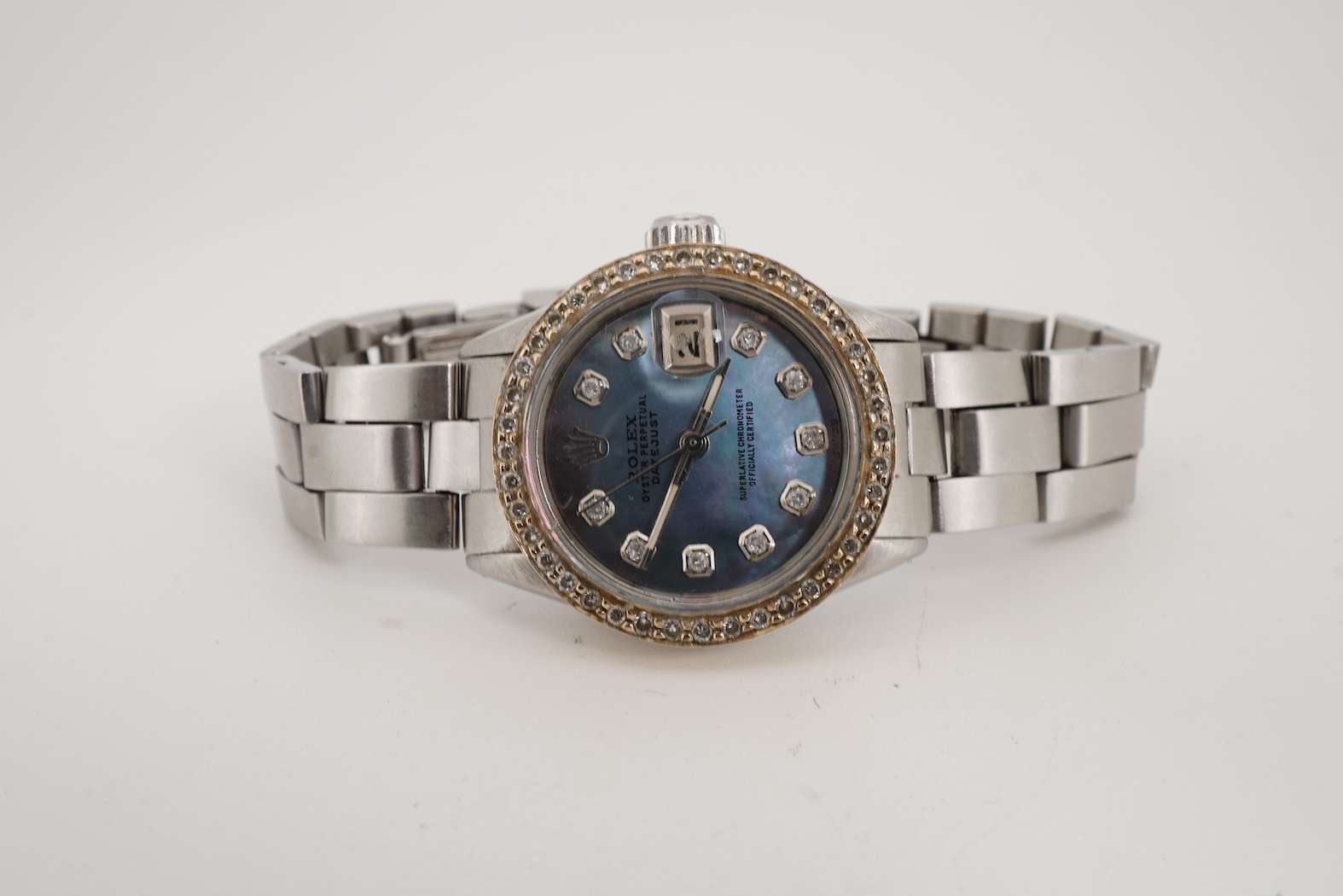 A lady's late 1960's stainless steel Rolex Oyster Perpetual Datejust, with later after market diamond set bezel and mother of pearl dial with diamond dot markers